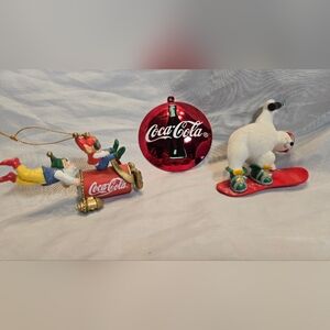 This lot of 3 vintage Coca-Cola Christmas ornaments features a hologram design o